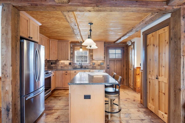 kitchen featuring a center island, light hardwood / wood-style floors, stainless steel appliances, and hanging light fixtures