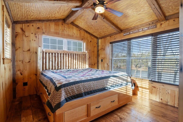 bedroom with wood-type flooring and wood walls