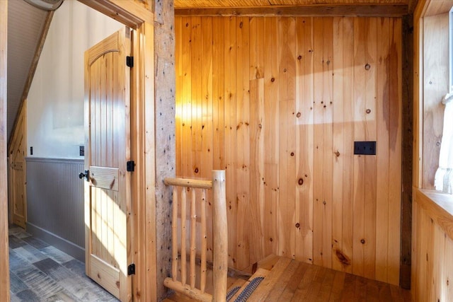 interior space with wooden walls and hardwood / wood-style floors