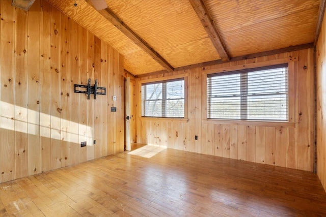 empty room with hardwood / wood-style flooring and wood walls