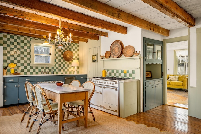 681 Sedgwick Ridge Rd, Sedgwick, ME 04676 - dining space with a chandelier, light wood-type flooring, and beam ceiling