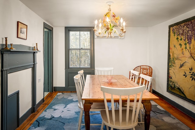 681 Sedgwick Ridge Rd, Sedgwick, ME 04676 - dining room with wood finished floors and a chandelier
