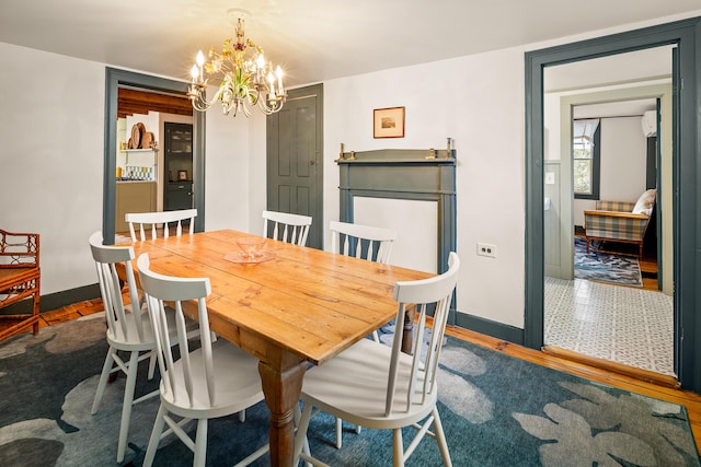 681 Sedgwick Ridge Rd, Sedgwick, ME 04676 - dining room featuring a chandelier and baseboards
