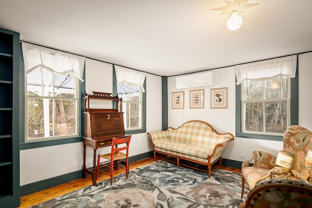 681 Sedgwick Ridge Rd, Sedgwick, ME 04676 - living area with a wall mounted AC, wood finished floors, and healthy amount of natural light