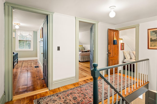 681 Sedgwick Ridge Rd, Sedgwick, ME 04676 - hallway with an upstairs landing and light wood-style flooring