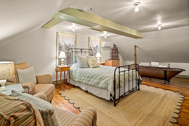 681 Sedgwick Ridge Rd, Sedgwick, ME 04676 - bedroom featuring a wall unit AC, vaulted ceiling, and wood finished floors
