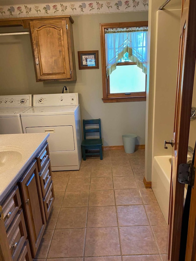 washroom featuring independent washer and dryer and light tile patterned floors