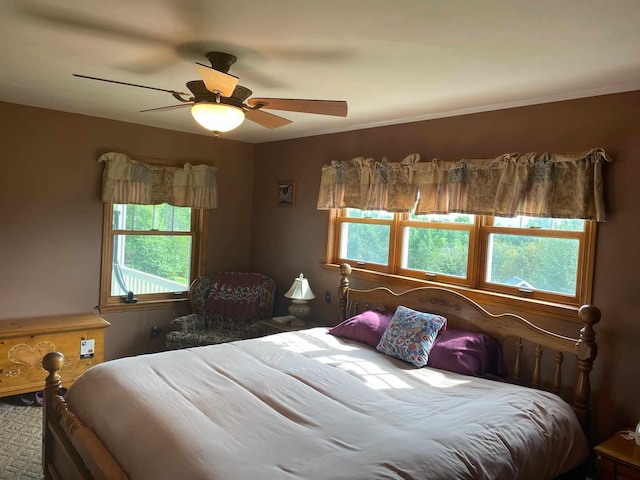 bedroom with ceiling fan and multiple windows