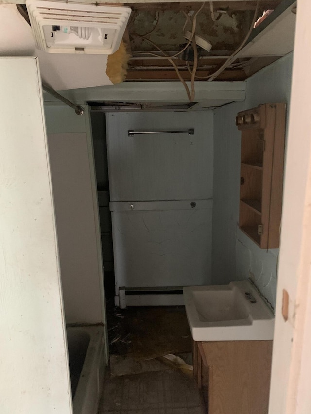 bathroom featuring a washtub and vanity