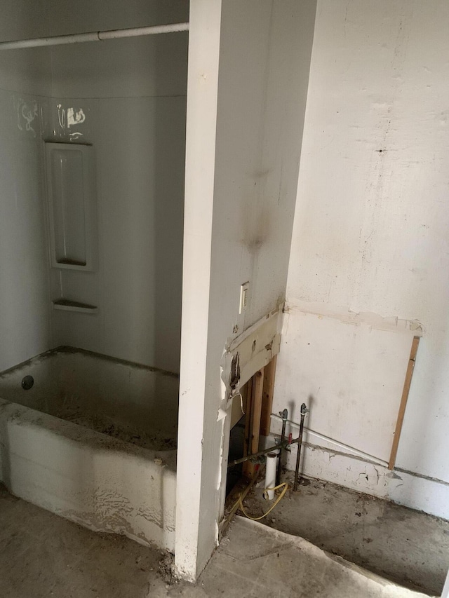 bathroom featuring a tub and concrete floors