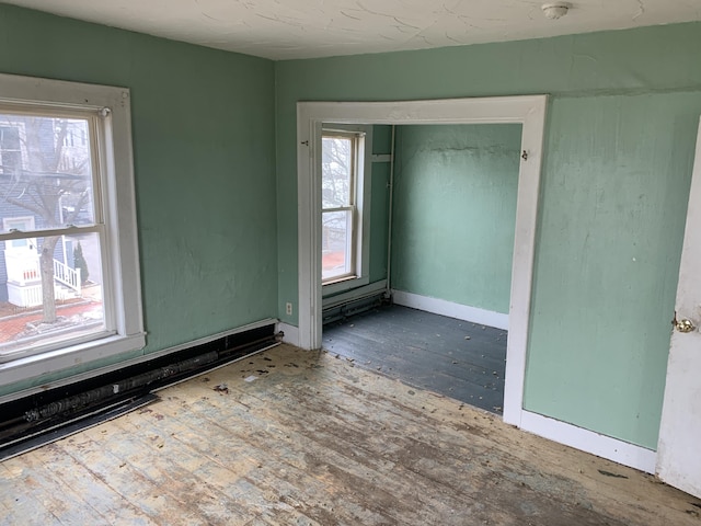 unfurnished room featuring wood-type flooring and a wealth of natural light