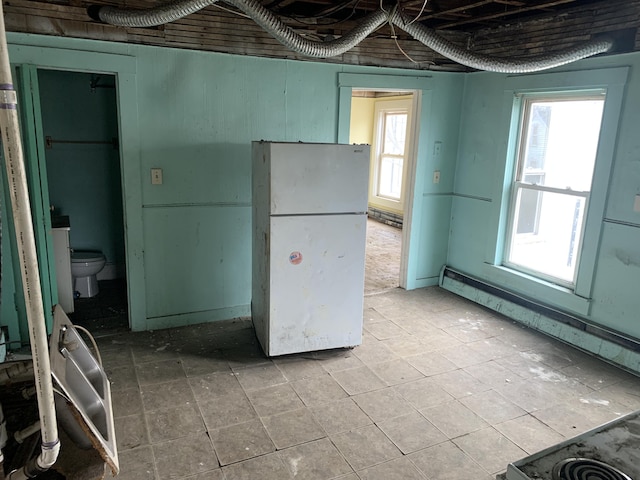 kitchen with plenty of natural light and white fridge