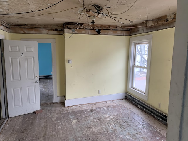 interior space featuring a baseboard radiator and light hardwood / wood-style flooring