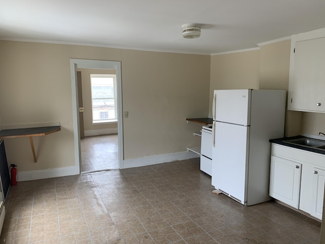 kitchen featuring sink, white cabinets, white appliances, and ornamental molding