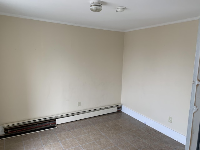 spare room featuring ornamental molding and a baseboard heating unit