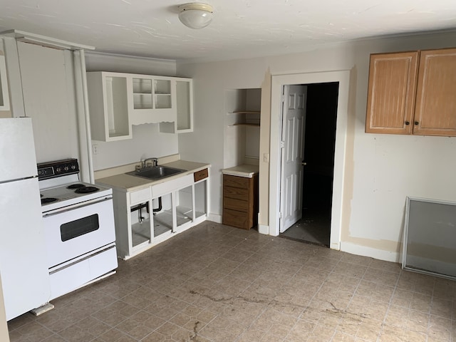 kitchen featuring light brown cabinetry, sink, and white appliances