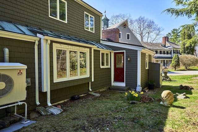 15 Brentwood Dr Unit 4, Cumberland, ME 04110 - back of house with metal roof, a standing seam roof, ac unit, and a yard