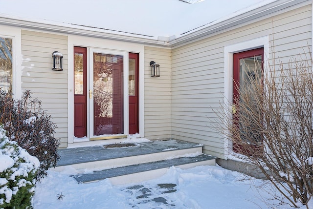 view of snow covered property entrance