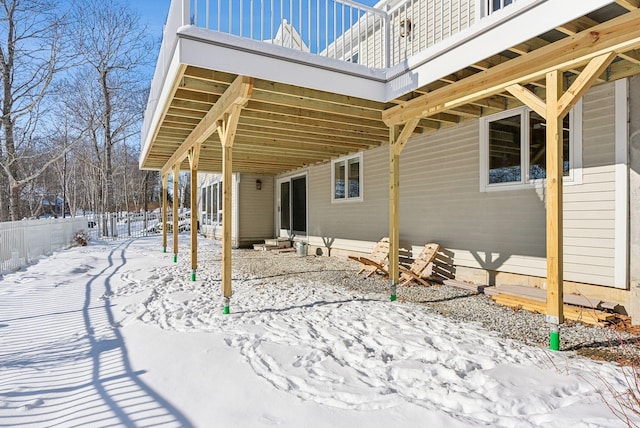 view of snow covered rear of property