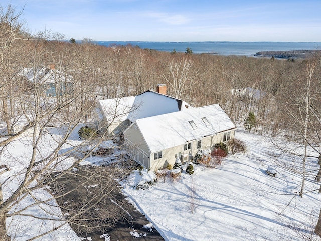 snowy aerial view with a water view