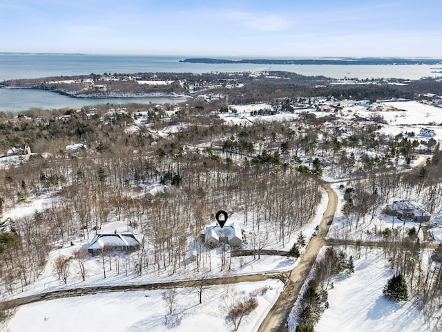 snowy aerial view with a water view