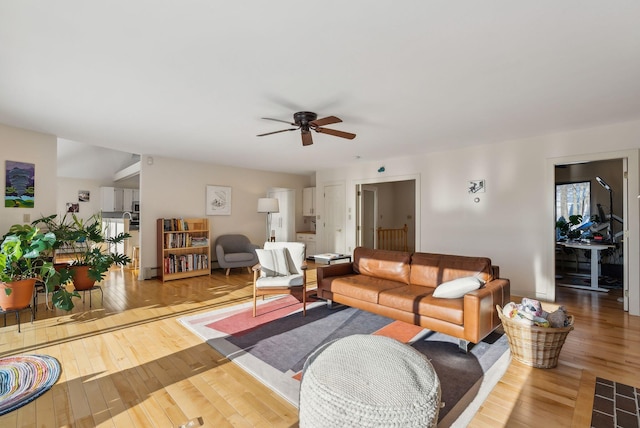 living room with ceiling fan and light wood-type flooring