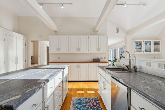 kitchen featuring sink, dishwasher, vaulted ceiling with beams, light hardwood / wood-style floors, and white cabinets