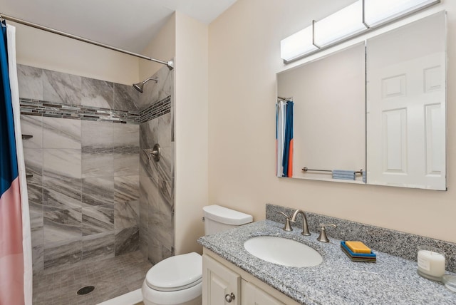 bathroom featuring vanity, toilet, and walk in shower