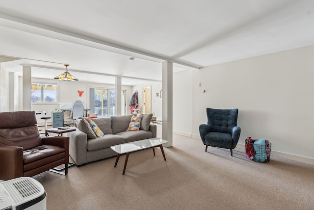 carpeted living room featuring beamed ceiling