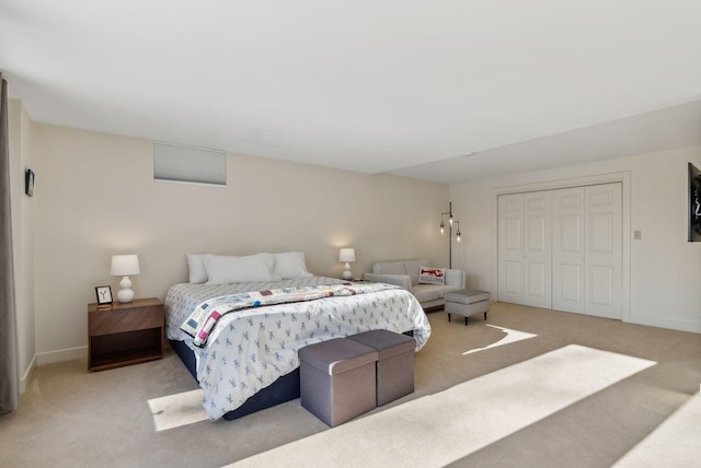 bedroom with light colored carpet and a closet