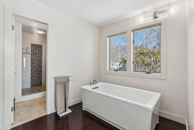 bathroom featuring hardwood / wood-style flooring and independent shower and bath