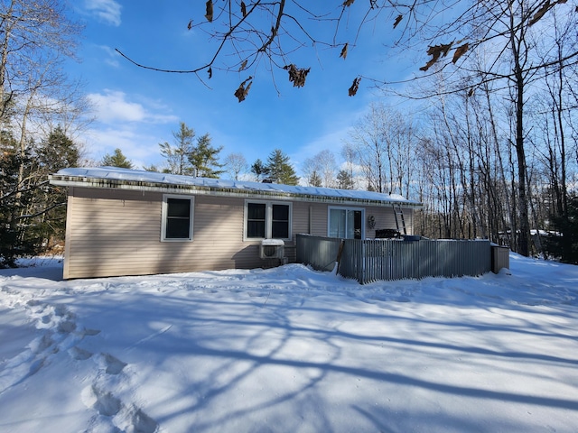 snow covered property with central AC unit