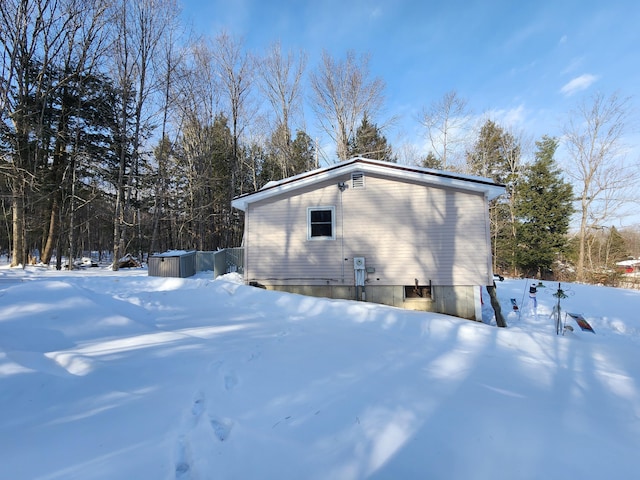 view of snowy exterior with a jacuzzi