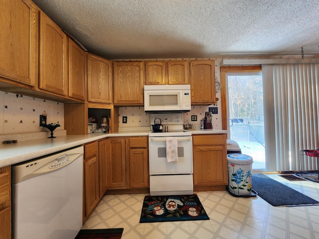 kitchen featuring white appliances and a textured ceiling