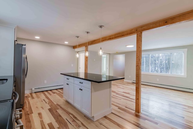 kitchen featuring white cabinetry, a center island, hanging light fixtures, and light wood-type flooring