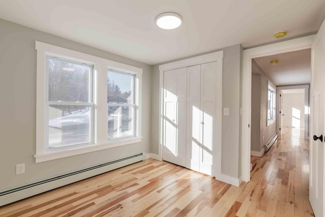 entryway with baseboard heating and light wood-type flooring