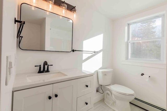 bathroom with vanity, a baseboard radiator, and toilet