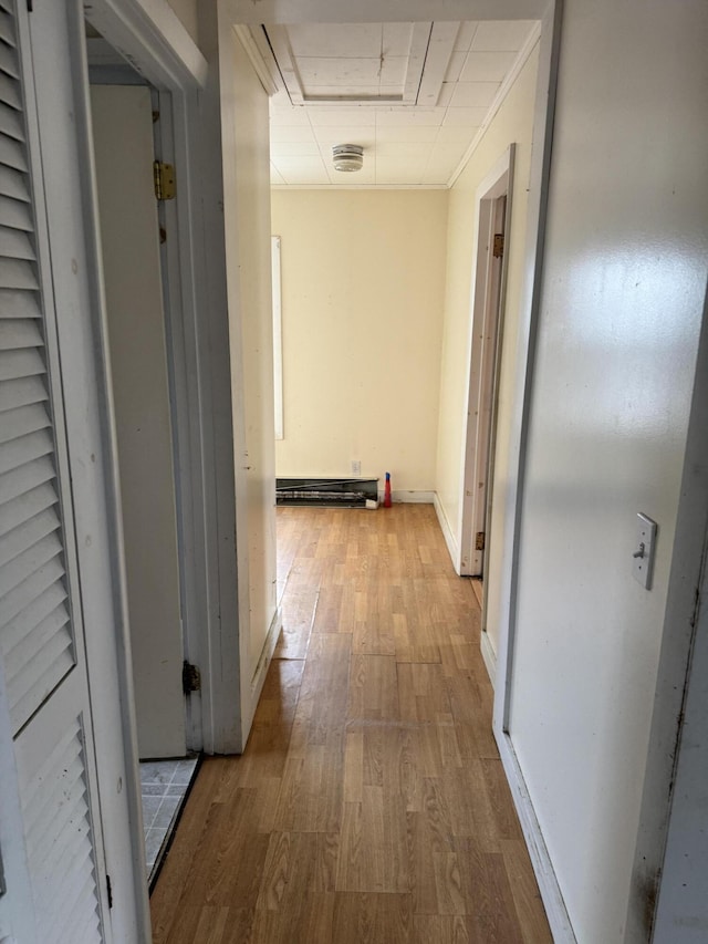 corridor with light hardwood / wood-style floors