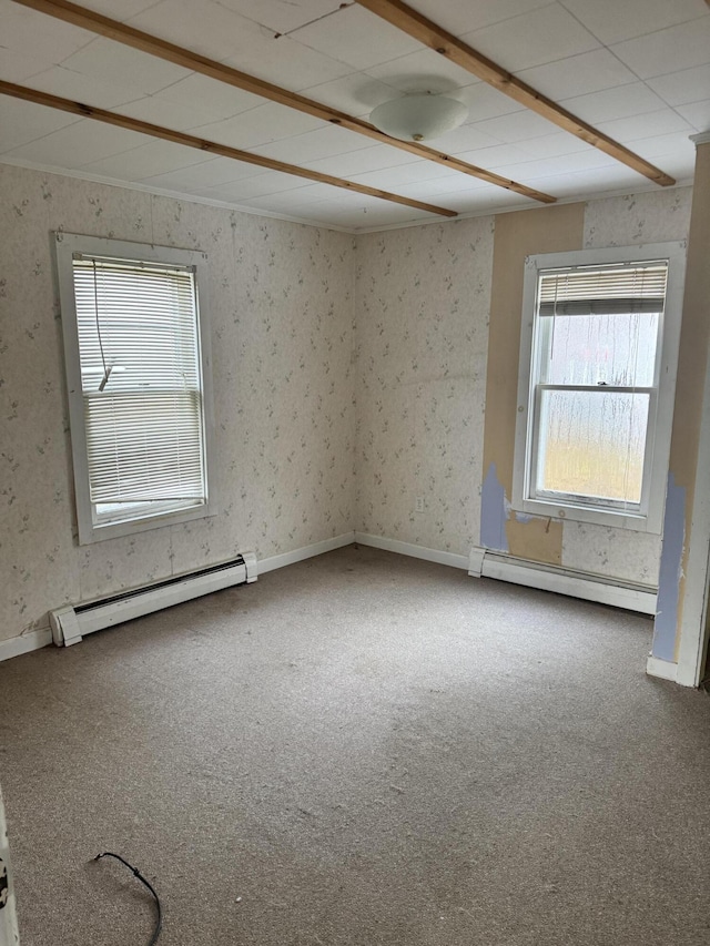 carpeted spare room with baseboard heating