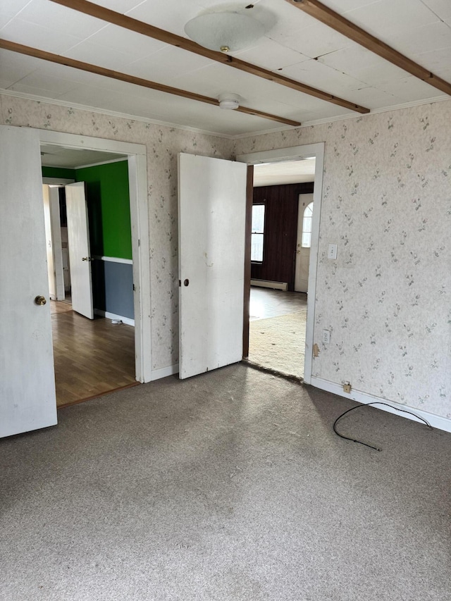 spare room with hardwood / wood-style flooring and a baseboard heating unit