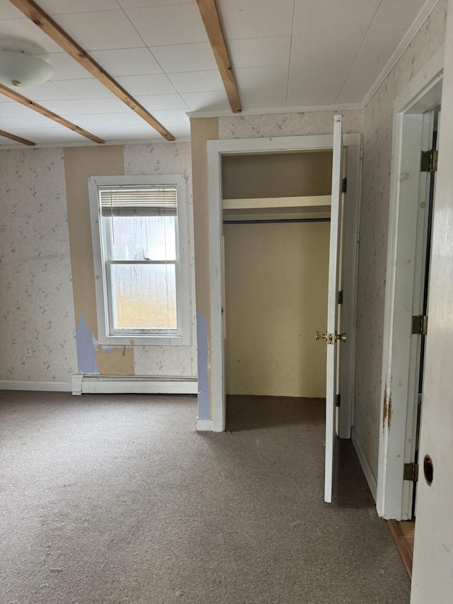 unfurnished bedroom featuring carpet flooring and baseboard heating