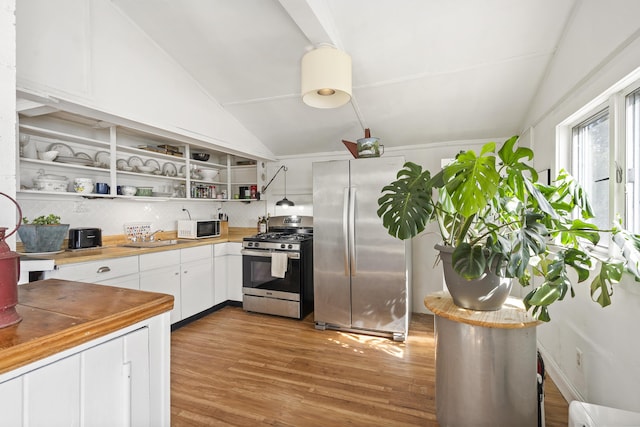 283 Mills Rd, Newcastle, ME 04553 - kitchen with light wood-style flooring, appliances with stainless steel finishes, open shelves, and lofted ceiling