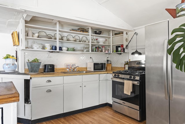 283 Mills Rd, Newcastle, ME 04553 - kitchen featuring a sink, open shelves, light wood-type flooring, and appliances with stainless steel finishes