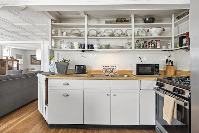 283 Mills Rd, Newcastle, ME 04553 - kitchen featuring open shelves, white cabinets, a sink, stainless steel gas range oven, and backsplash