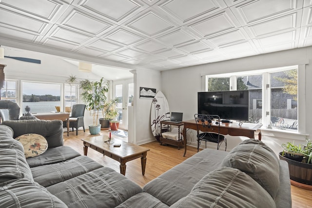 283 Mills Rd, Newcastle, ME 04553 - living area featuring light wood-style flooring, baseboards, an ornate ceiling, and a water view