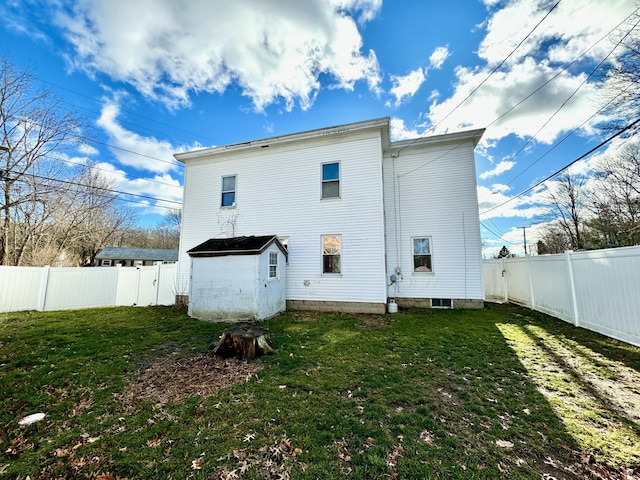 rear view of property with a yard