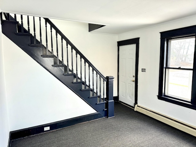 carpeted entrance foyer with baseboard heating and ornamental molding