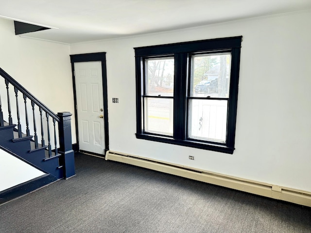 carpeted foyer entrance featuring ornamental molding and a baseboard radiator