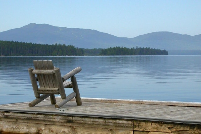 view of dock featuring a water and mountain view