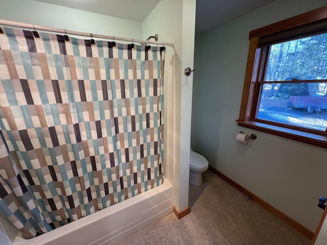 bathroom with shower / bath combo with shower curtain and toilet